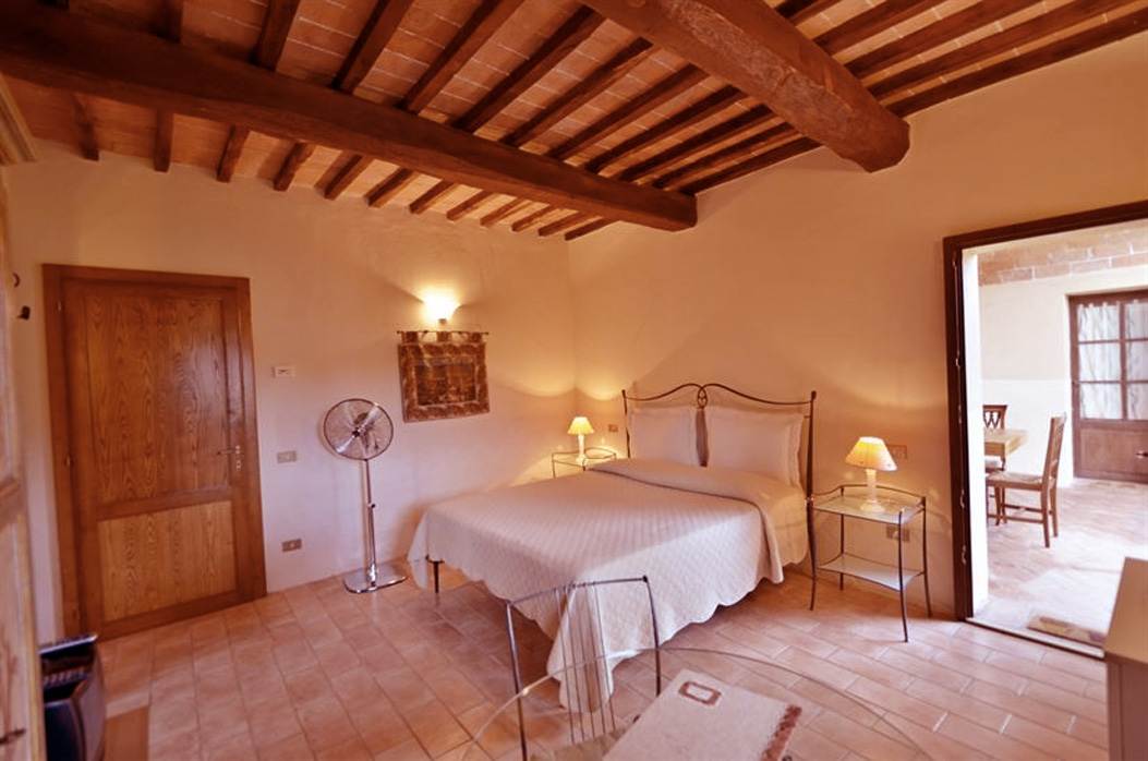 camera con letto in ferro battuto toscano